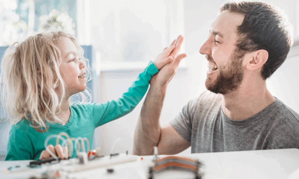 Photo of a father and his child high-fiving