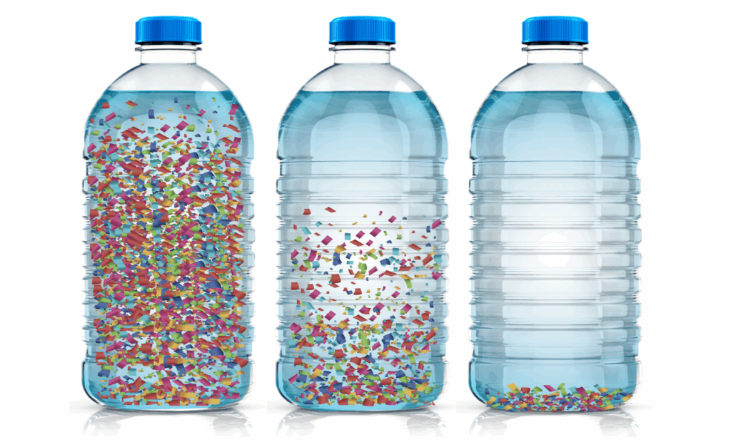 Photo of three bottles filled with liquid and various amounts of confetti